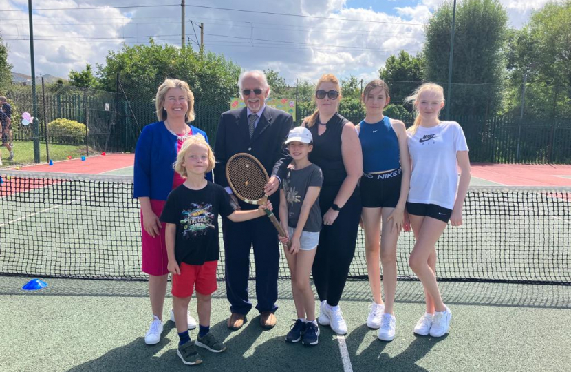 Wearing white tennis shoes, Anna Firth MP joins members of the Invicta Tennis Club to celebrate 75 years of the club’s existence