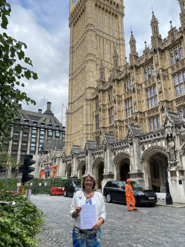 Anna Firth MP with statute outside Big Ben 